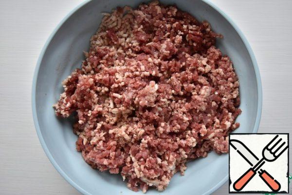 Meanwhile, twist the meat in a meat grinder with a large grate or chop with a knife.