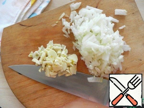 One onion and three cloves of garlic cut into small cubes.