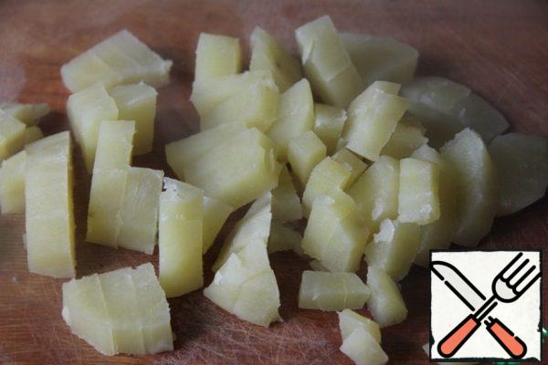 Potatoes pre-boil until soft (about 10 minutes), cut into cubes. Add to onions and carrots.
