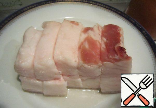 A piece of bacon cut into pieces about 3 cm thick