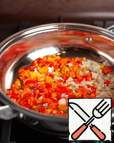 Fry the bell peppers in vegetable oil for 3 minutes, then add the onion and fry for another couple of minutes.