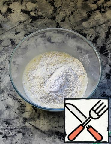 In the oil-egg mixture, add the sifted flour (parts) and baking powder.
Flour may need a little less or more.