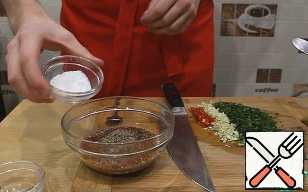 Pour spices into 100 ml of mineral water: ground paprika, ground pepper, oregano, cumin and salt.
