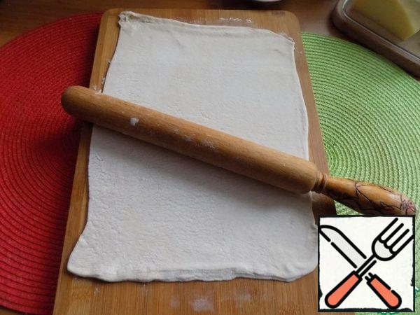 The dough should be rolled out, dusting the work surface with flour. The thickness of the dough is ~ 05-0. 7 cm.