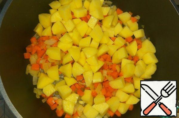Add the peeled and diced potatoes, fry for a couple of minutes, stirring.
