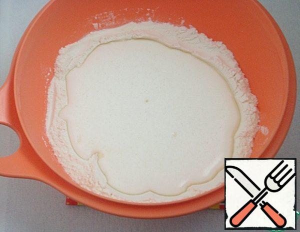 Make a depression in the center of the dry ingredients, pour the egg-milk mixture.