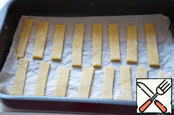 Transfer the strips to a baking tray. Brush with the remaining egg, sprinkle with seeds.
