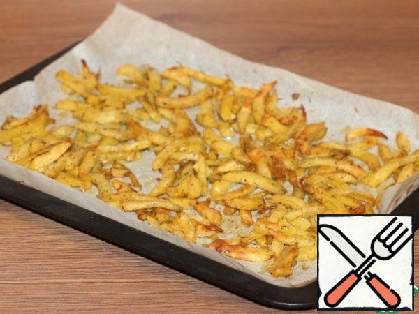 Cover the baking sheet with baking paper and grease with vegetable oil. Spread the potatoes. Send a baking sheet with potatoes in a well-heated to 230 C oven for 20-30 minutes. Be guided by your oven.