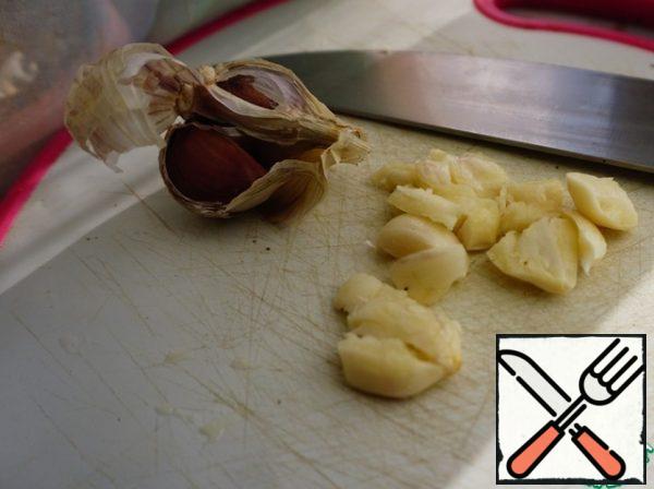 Garlic clean and press with a knife.