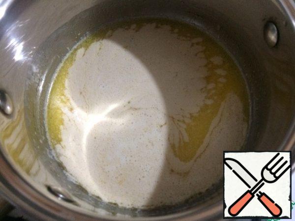 Melt the butter in a saucepan over very low heat. Remove from the stove and add a glass of cold milk, the temperature will be just right for the dough. Add sugar and salt and mix thoroughly until completely dissolved. Add the yeast, mix well and leave the yeast to "dissolve" a little.
