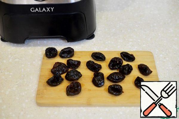 Cut in half lengthwise. If prunes are pitted, remove it.