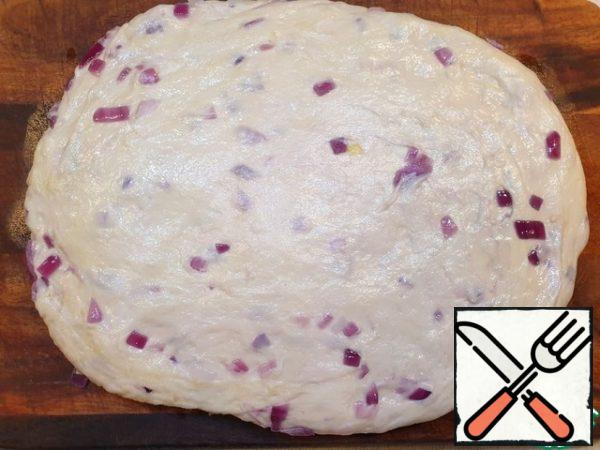 Roll out or stretch the dough with your hands into a layer, about 1 cm thick.