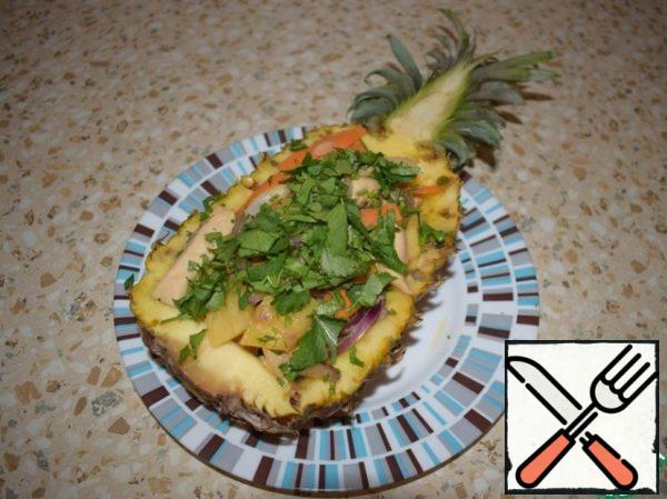 Put in half a pineapple, garnish with chopped herbs.
Bon appetit.