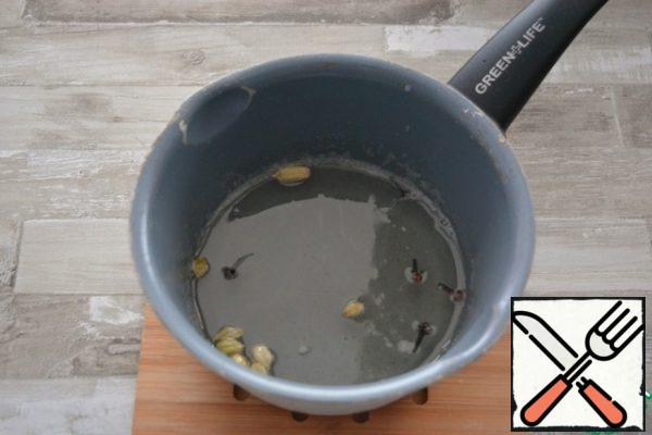 Pour in the water, bring to a boil and cook the syrup for 5 minutes.
