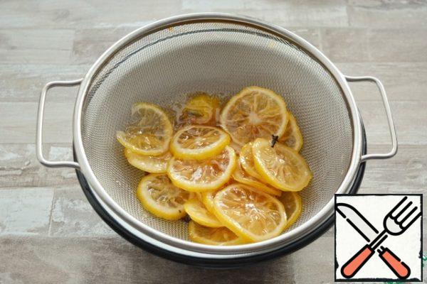 Cook the lemons for 20-30 minutes, then discard on a sieve and let the syrup drain, remove the spices.
