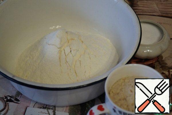 Sift the flour. In a mug, heat up a little milk and dilute it with dry yeast and a teaspoon of sugar. Leave for 10 minutes so that the yeast begins to act.
