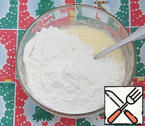 Gradually add the flour mixture, continuing to work with a spoon.