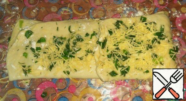 Fold in half, spread with butter, sprinkle with flour, herbs +cheese.