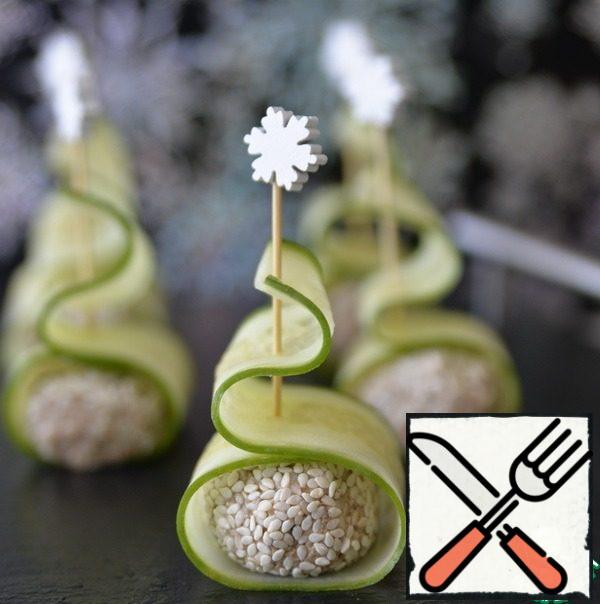 Put a ball of pate on a strip of cucumber. Wrap the ball in a strip, fasten with a skewer.
Happy New Year!