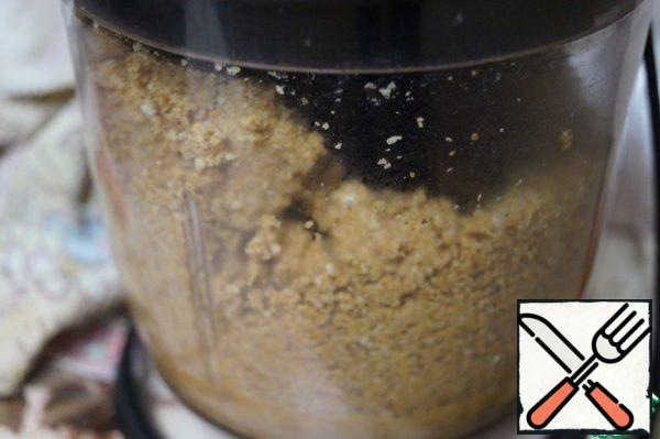 Grind the peanuts and sesame seeds in a blender to a flour state.