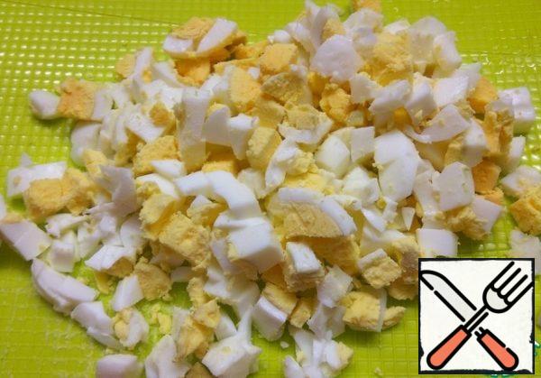 Hard-boiled eggs. Peel and cut into small pieces.