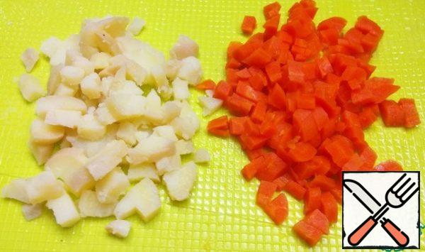 Boil carrots and potatoes in their skins. Peel and cut into small cubes.