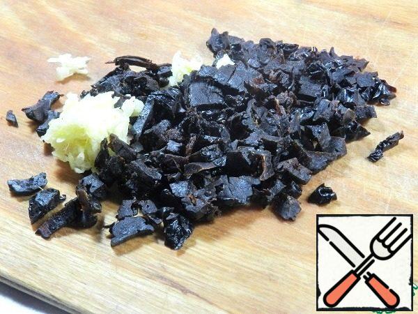 Prunes (4-5 pieces) cut finely, grate the garlic on a small grater.