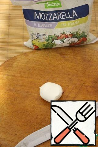 Cut mozzarella balls into quarters.