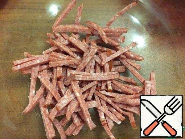 Cut the sausage into strips ( Servelat is very suitable).