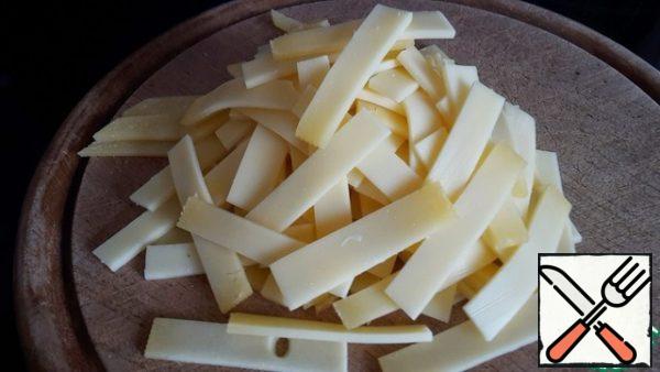 Meanwhile, cut the cheese and sausage into large strips.