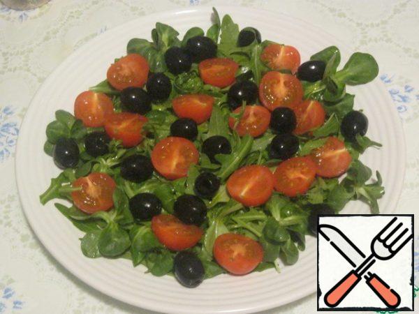 Lay out the olives and tomato halves.