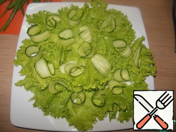 Cucumbers cut into slices, twist and spread on top.