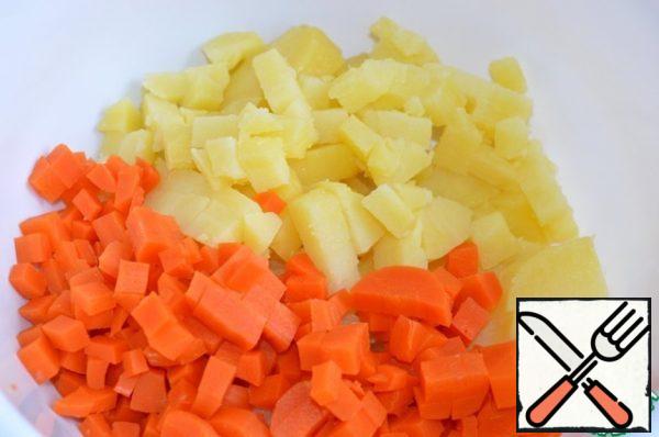 Cut potatoes and carrots into small cubes.