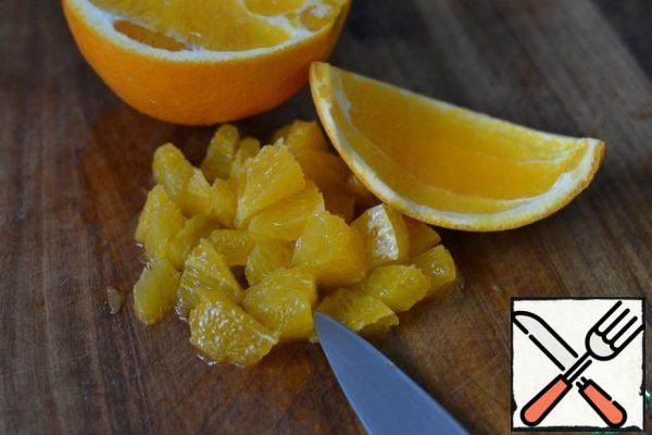 Peel half an orange. Cut into small pieces.
