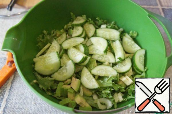 Cut the cucumber into thin half rings and put it in a bowl with salad.
