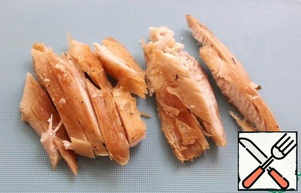 Cut chicken pieces into strips.