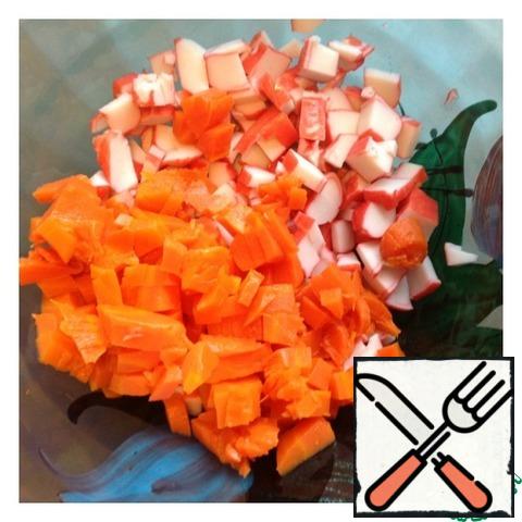 Peel the carrots and cut into small cubes like crab sticks.