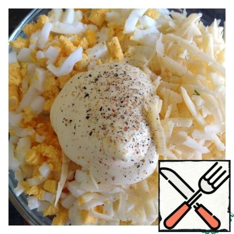 Grate the cheese on a large grater, cut the eggs into cubes. Add spices and mayonnaise. Mix the salad.