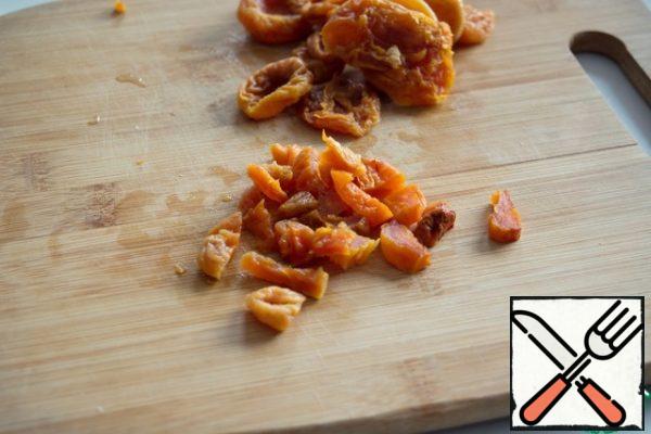 Soak dried apricots in warm water for 15 minutes, dry and finely chop.
