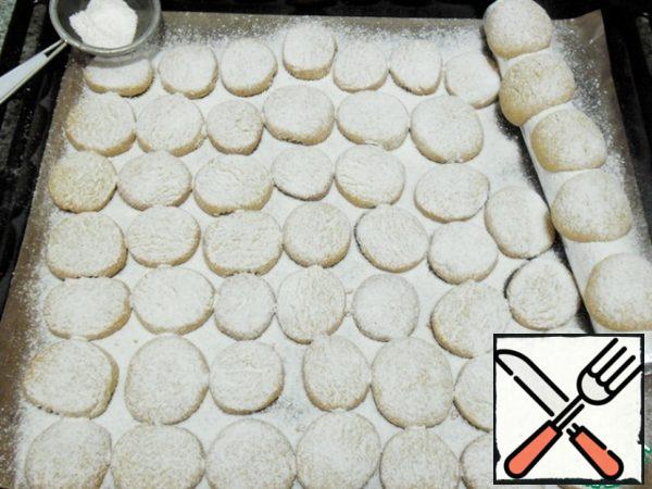 Send a baking sheet with cookies in the prepared oven for 7-10 minutes.
Once removed from the oven-sprinkle generously with powdered sugar, it will stick better on the cookies.