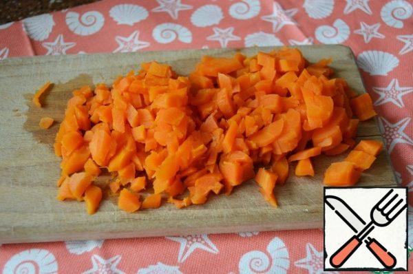 Cut the carrots into cubes and add them to the potatoes.