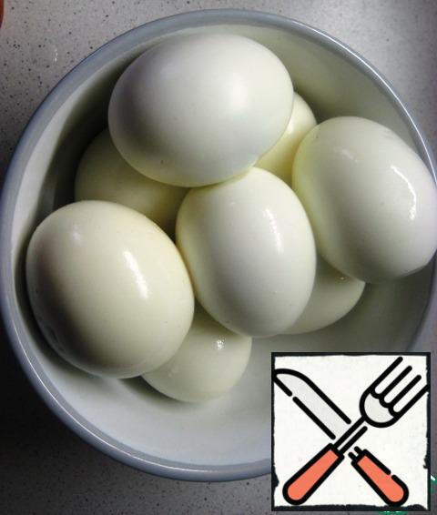 Hard-boiled eggs. Carefully clean, cut into halves, remove the yolk.