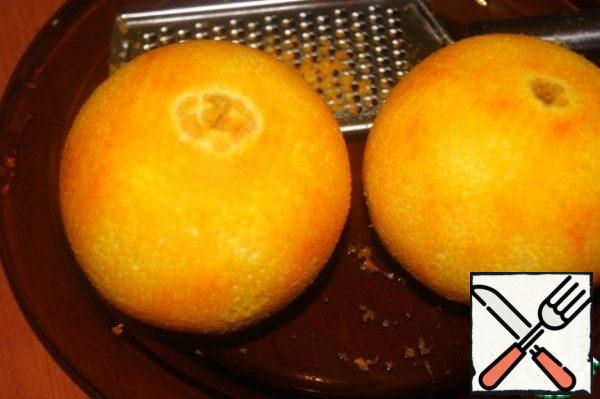 Using a grater, remove the zest from the oranges.
