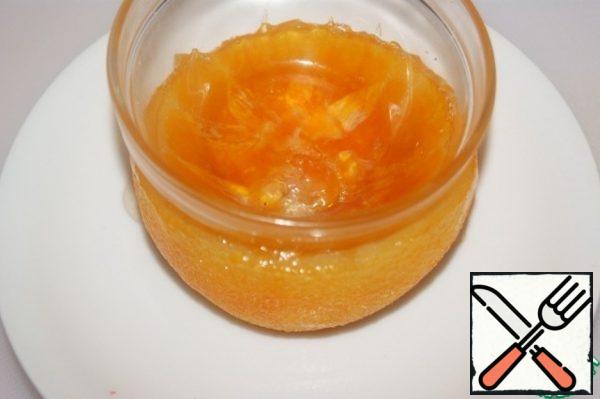 Using a small container, gently press down the orange pulp to make a recess for the cream.