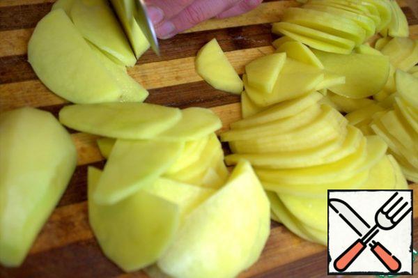 Peel the medium potatoes and cut them in half.