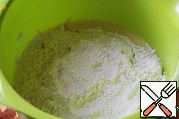 Add flour mixed with baking powder, mix.
