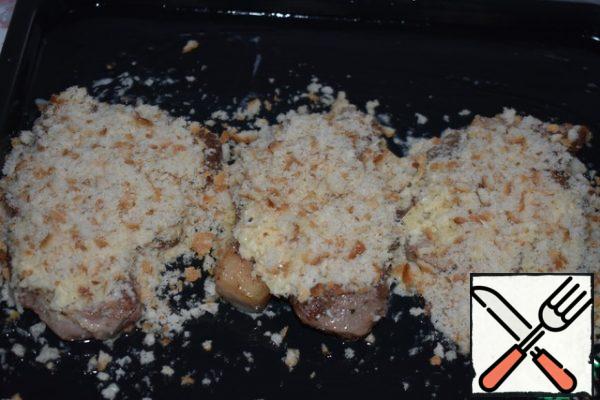 Grate cheese. Mix sour cream, egg, cheese and salt to fill. Put the oven on heating up to 180 gr. Put the meat on a greased baking sheet. Cover it with filling and cover with bread crumbs. Crumb lightly pressed to the meat with the palm of your hand.