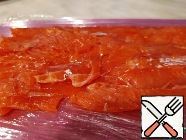 Any salted fish cut thinly.
Spread in a single layer on a Board wrapped with cling film (then it is easier to form a roll)