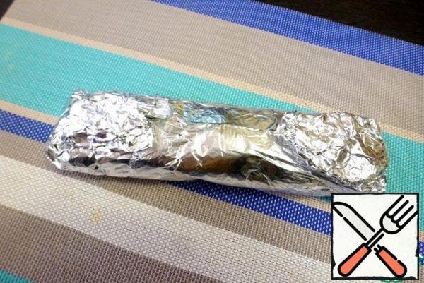 Wrap the roll in foil and send it in a preheated 190 degree oven for 30-40 minutes. The time depends on the thickness of the roll.
Allow the roll to cool and transfer to a convenient container. Without unwrapping the foil, put a small load on top, so that the roll is compacted, but not much flattened. Put in the refrigerator.