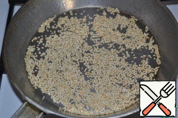 Fry sesame seeds in a pan until Golden brown.